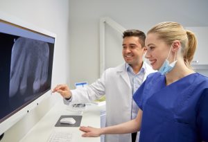 dentist and team looking at x-rays